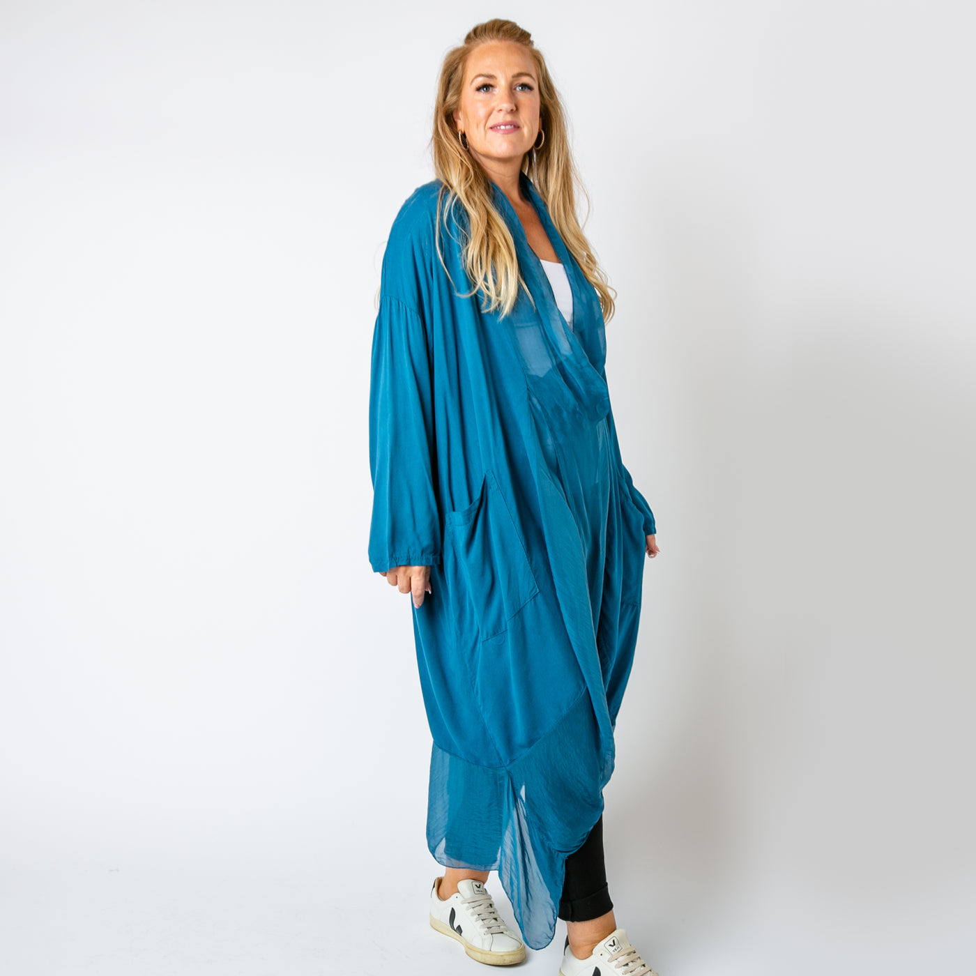 The teal blue Two Pocket Crossover Tunic with a draped low hanging cowl neckline 