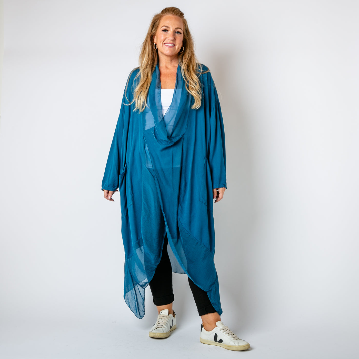 The teal blue Two Pocket Crossover Tunic with an asymmetric silk hemline