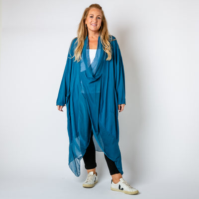 The teal blue Two Pocket Crossover Tunic with an asymmetric silk hemline