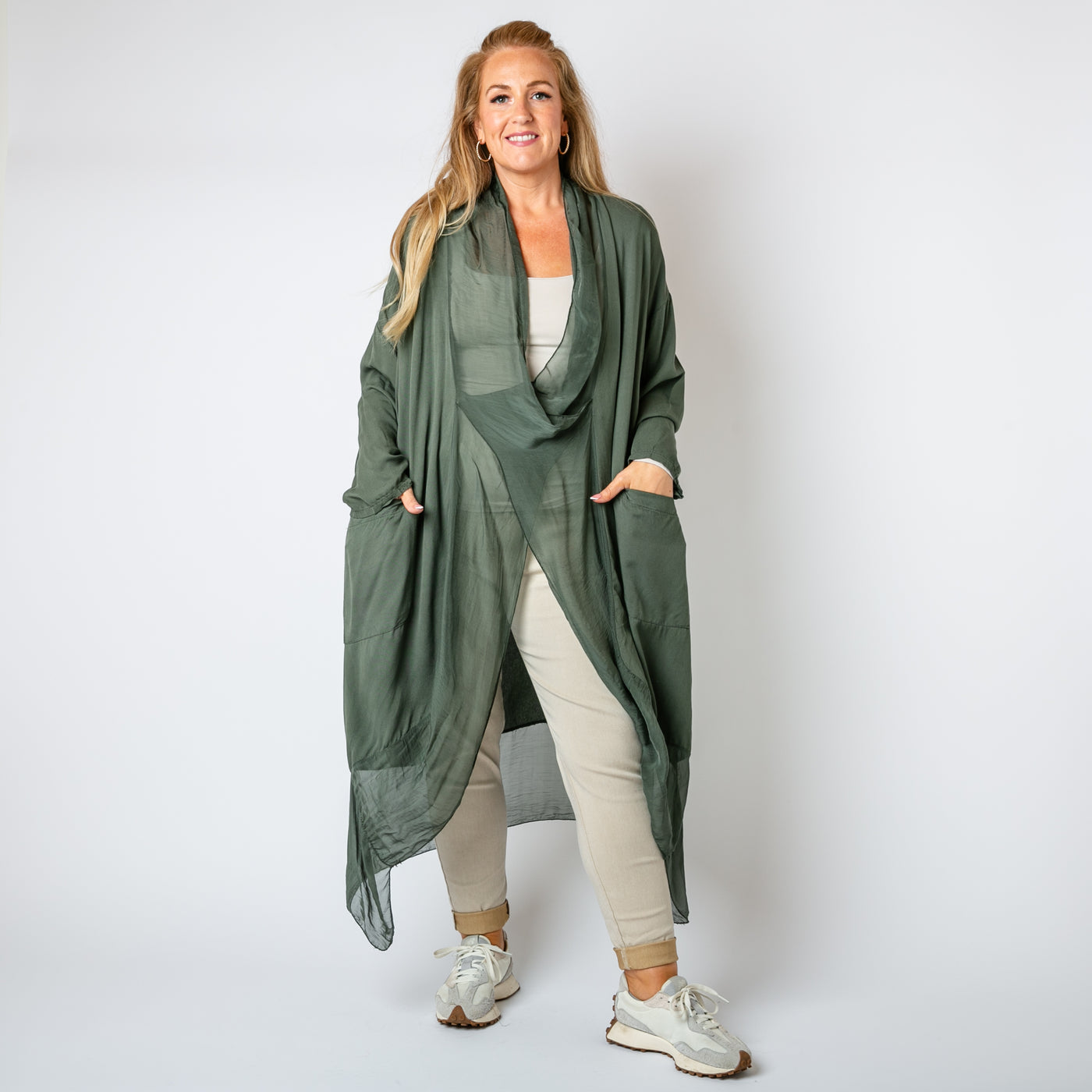 The khaki green Two Pocket Crossover Tunic with long sleeves and a loose fit