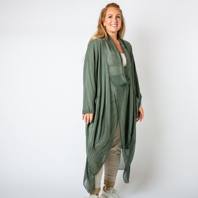 The khaki green Two Pocket Crossover Tunic with an asymmetric silk hemline