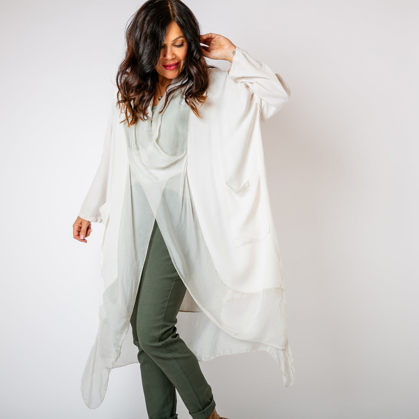 The stone cream Two Pocket Crossover Tunic with a draped low hanging cowl neckline 