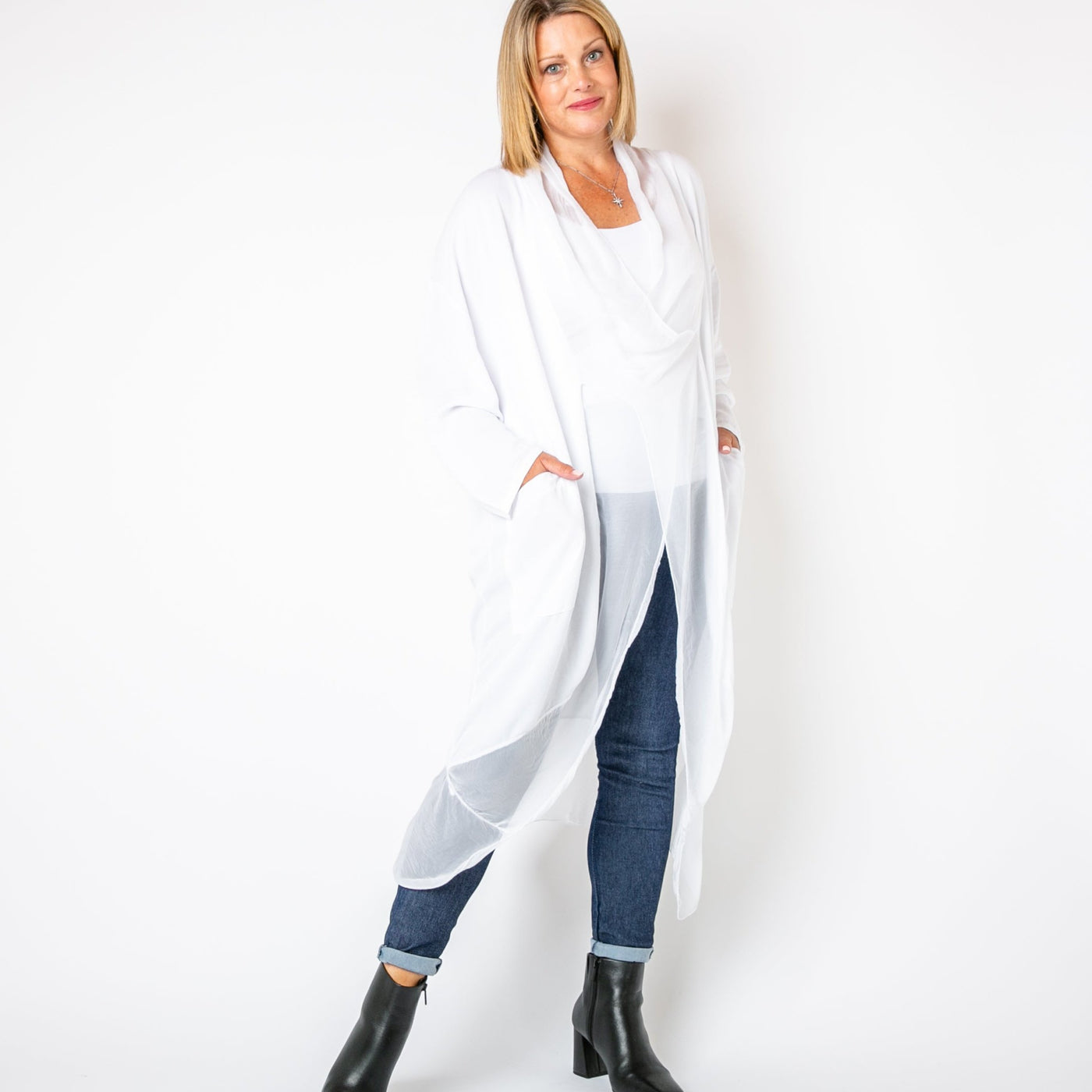 The white Two Pocket Crossover Tunic with long sleeves and a loose fit