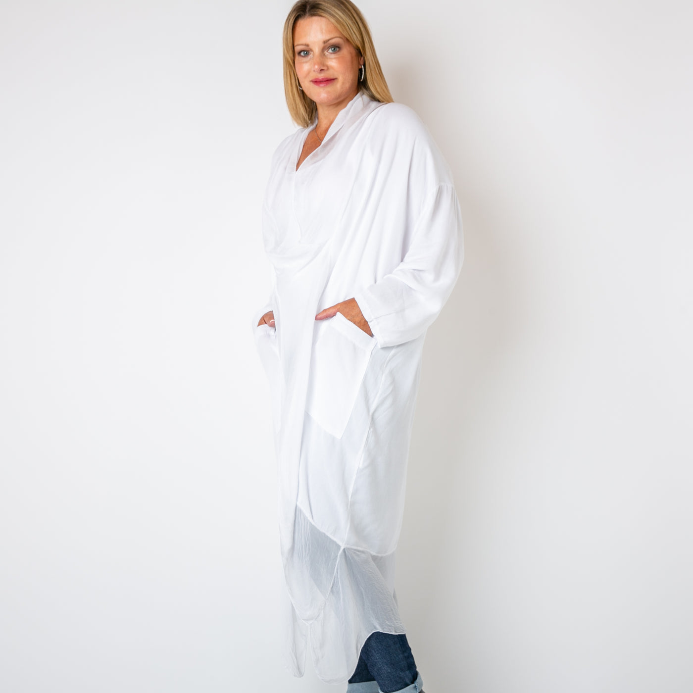 The white Two Pocket Crossover Tunic with a draped low hanging cowl neckline 