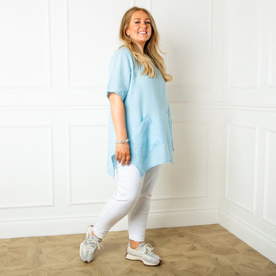 The baby blue Two Pocket Linen Top with slanted pockets on either side of the waist