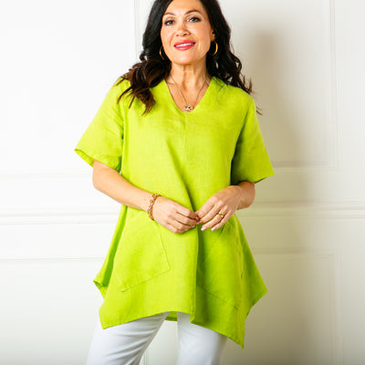 The lime green Two Pocket Linen Top with a statement flared hemline