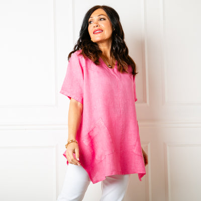 The raspberry pink Two Pocket Linen Top with slanted pockets on either side of the waist