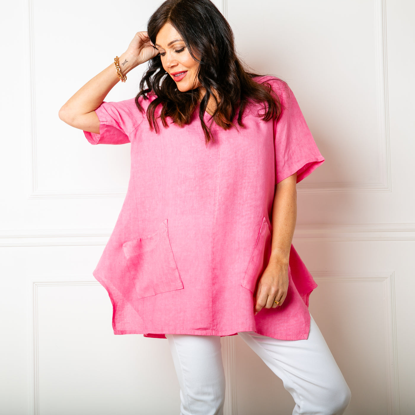 The raspberry pink Two Pocket Linen Top with a statement flared hemline
