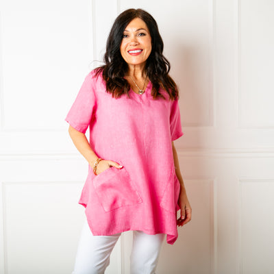 The raspberry pink Two Pocket Linen Top with short sleeves and a rounded v neckline 