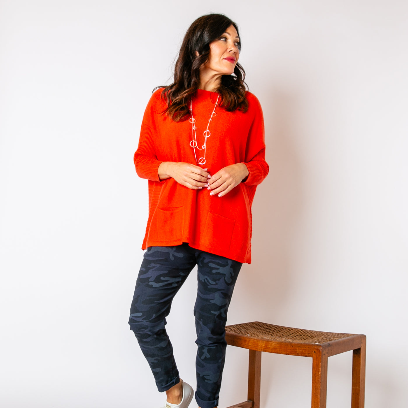 The orange Two Pocket Ribbed Sleeve Jumper with long sleeves with stretchy ribbed cuffs