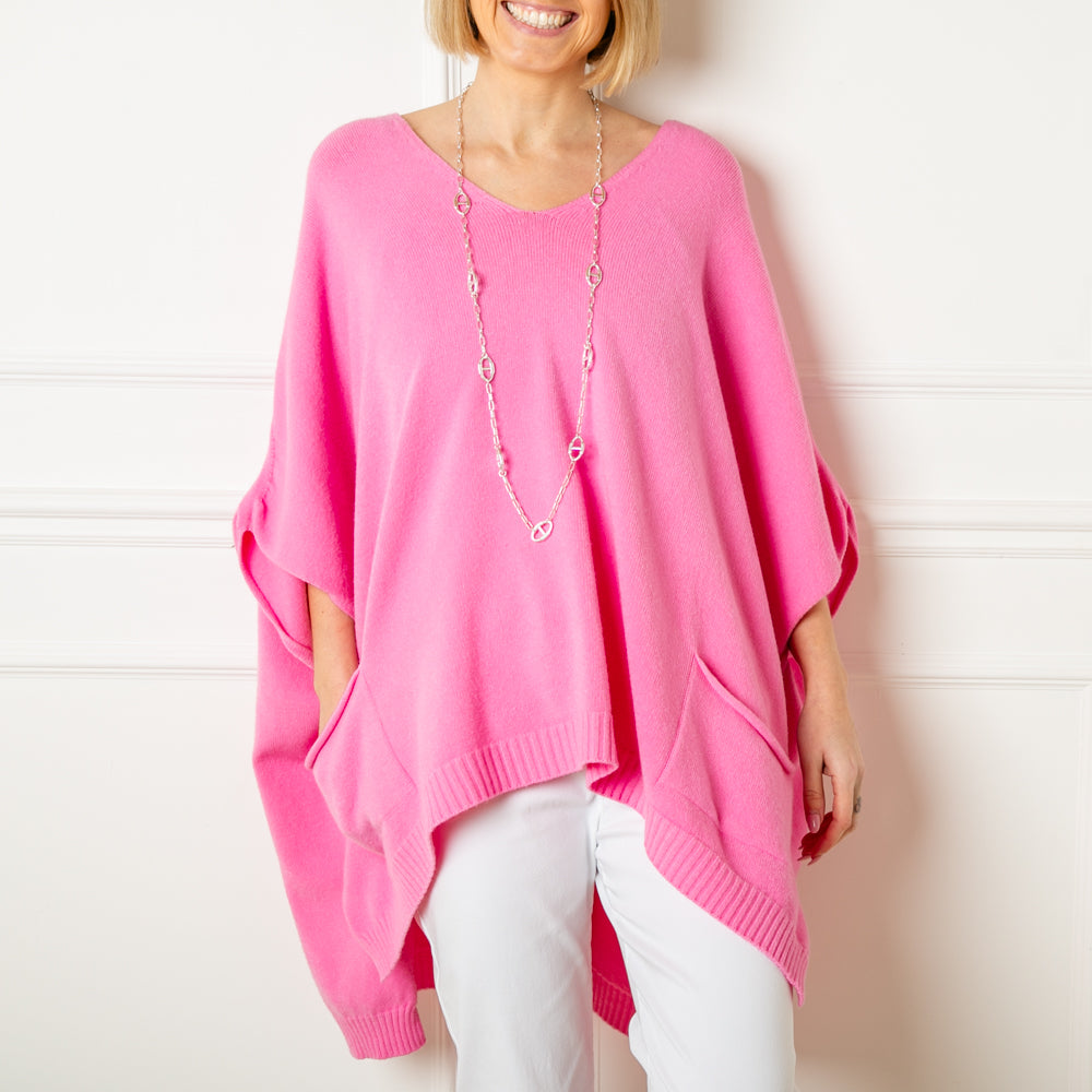 The pink V neck pocket poncho jumper with 3/4 length sleeves that fall to the elbow and pockets on either side of the front