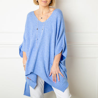 The dusky blue V neck pocket poncho jumper with 3/4 length sleeves that fall to the elbow and pockets on either side of the front