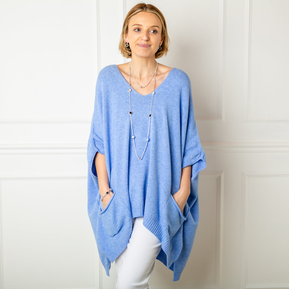 The dusky blue V Neck Pocket Poncho in a relaxed silhouette made from a fine knitted material