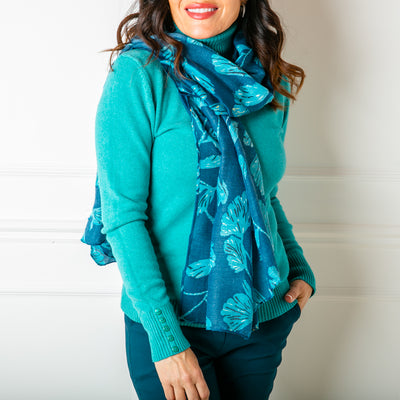 The Vienna Scarf in blue featuring a beautiful leaf print with metallic details