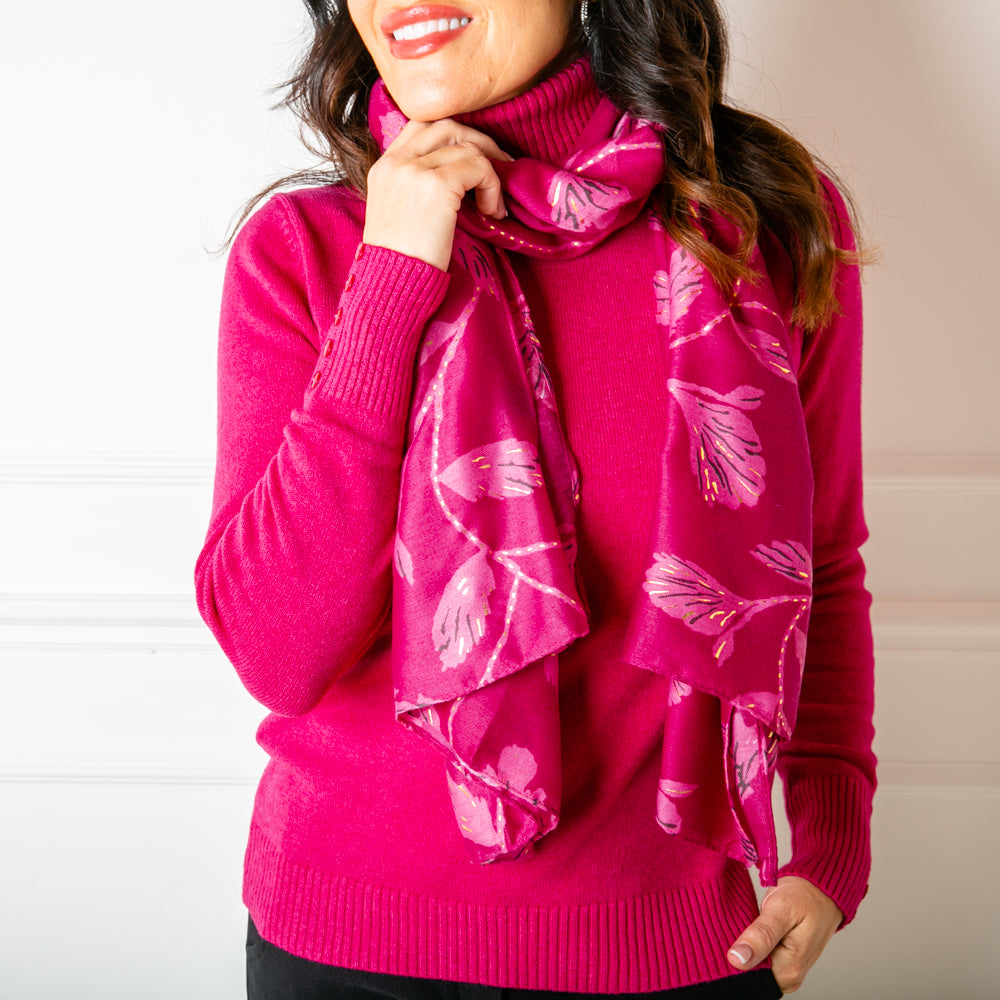 The Vienna Scarf in fuchsia pink featuring a beautiful leaf print with metallic details