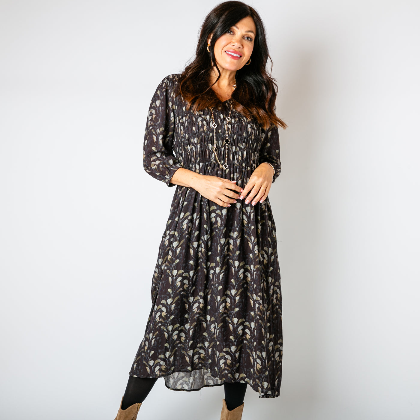 The chocolate brown Watercolour Leaf Shirred Dress with pockets on either side of the hip