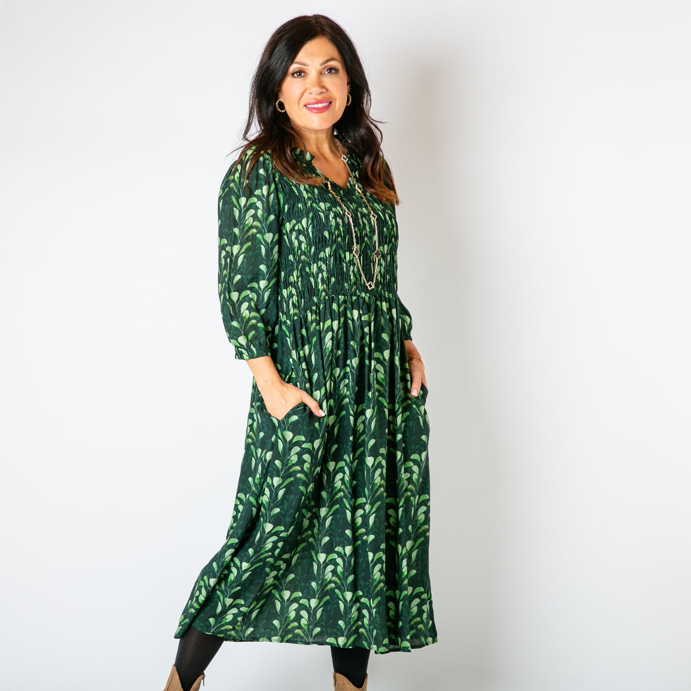 The emerald green Watercolour Leaf Shirred Dress featuring a beautiful natural leaf pattern