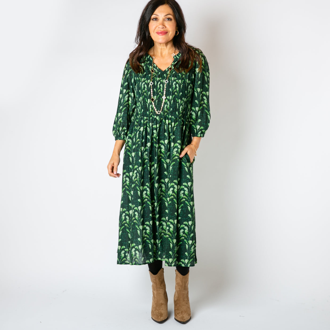 The emerald green Watercolour Leaf Shirred Dress with a shirred stretchy panel over the bust