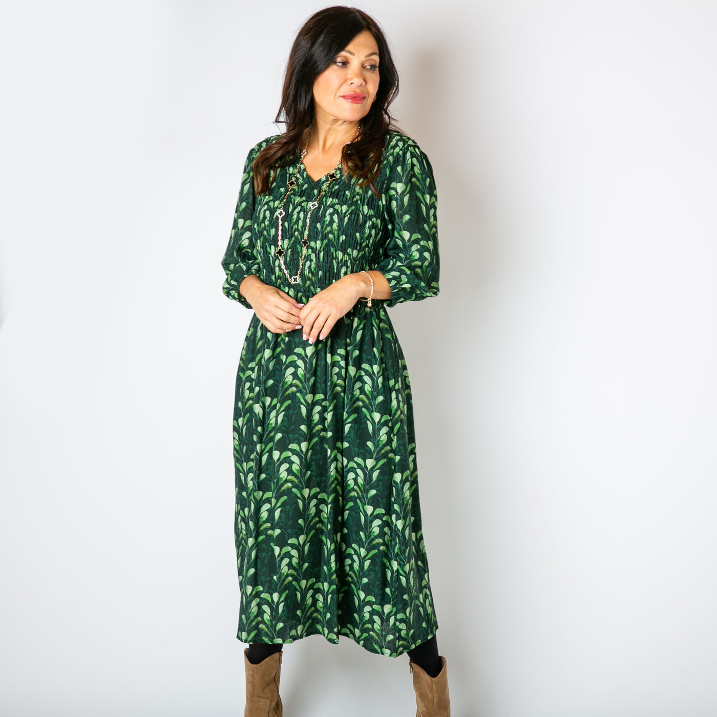 The emerald green Watercolour Leaf Shirred Dress with pockets on either side of the hip