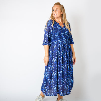 The navy blue Watercolour Leaf Shirred Dress featuring a beautiful natural leaf pattern