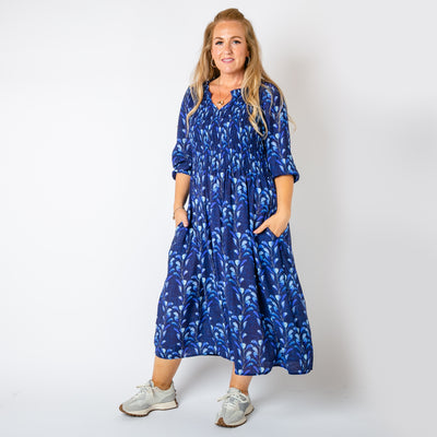 The navy blue Watercolour Leaf Shirred Dress with a shirred stretchy panel over the bust