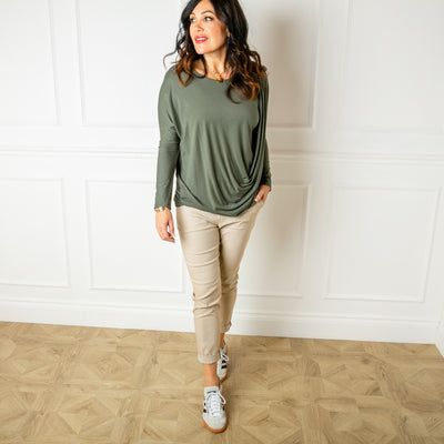 The khaki green Waterfall Long Sleeve Top for women featuring beautiful draping from one shoulder across the body for a very flattering look