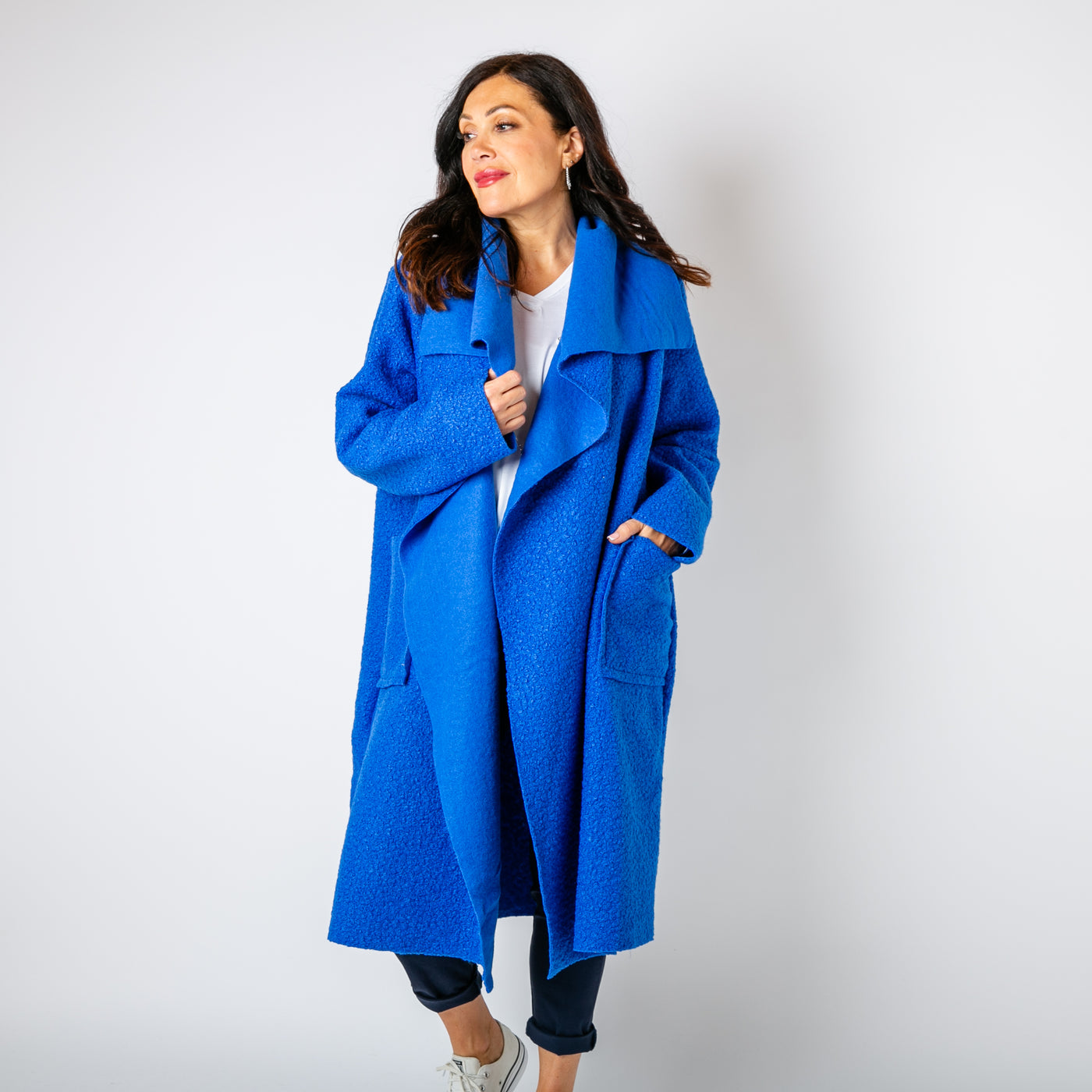 The royal blue Waterfall Roll Sleeve Coat with long sleeves and pockets on either side 