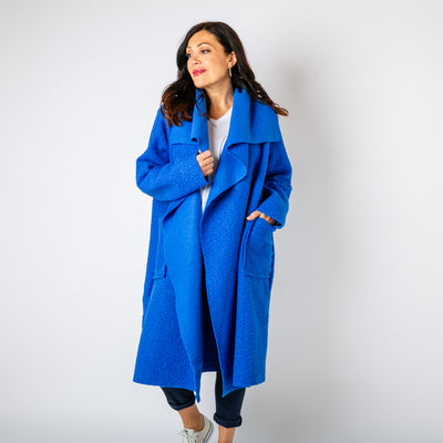 The royal blue Waterfall Roll Sleeve Coat with long sleeves and pockets on either side 