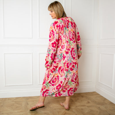 The pink Wild Garden Maxi Dress with buttons down the front and elasticated shirring over the bust for added stretch