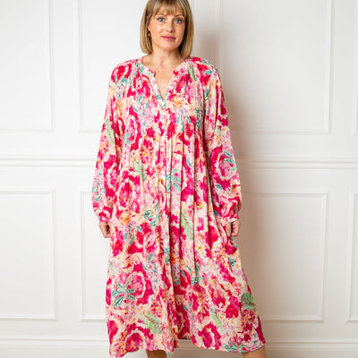 The pink Wild Garden Maxi Dress with long balloon sleeves and a collarless v neckline