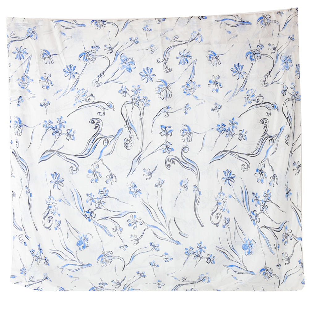 The Blue Cherry Blossom Silk Scarf in white with accents of blue and black