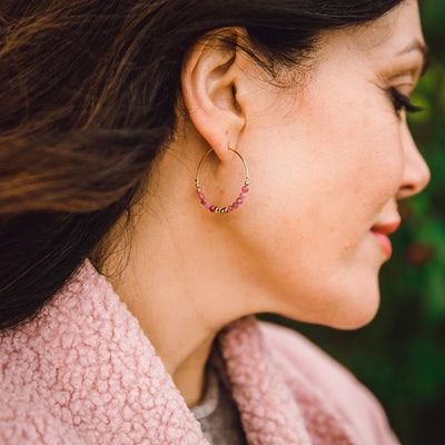 Alicia Hoop earrings shown on a model, delicate pink beads, gold hoops, easy to wear, delicate earrings