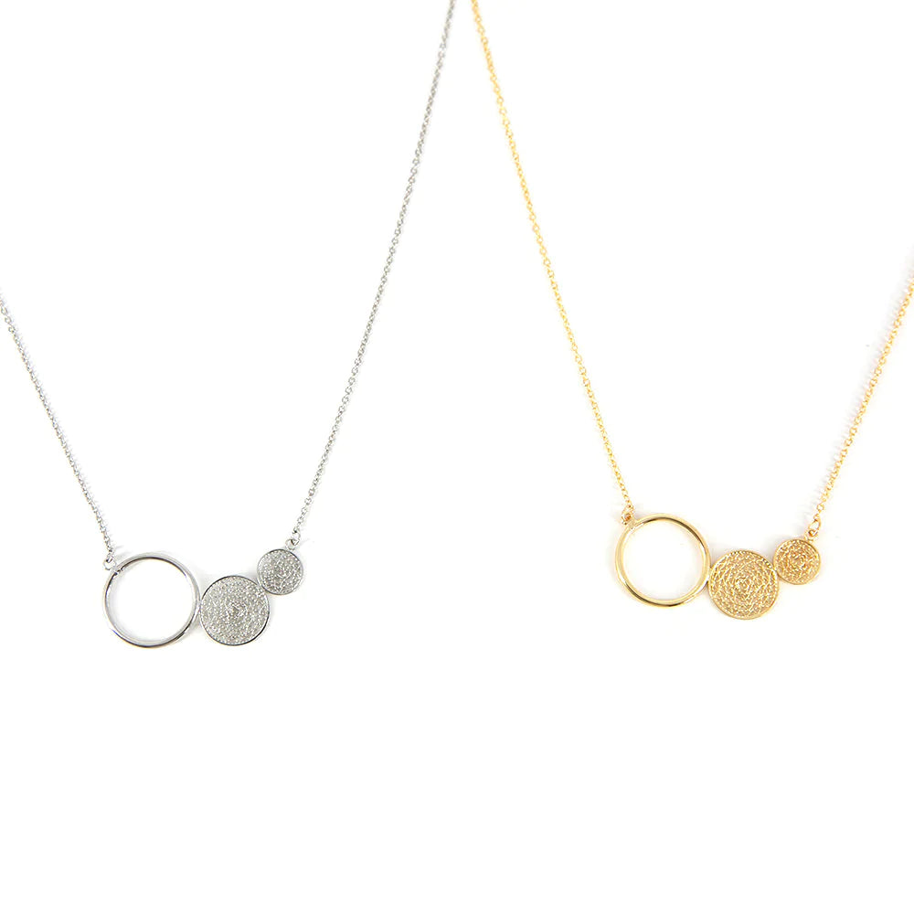 Alora Necklace, lightbox image of both gold and silver, delicate chain, dream catcher design 