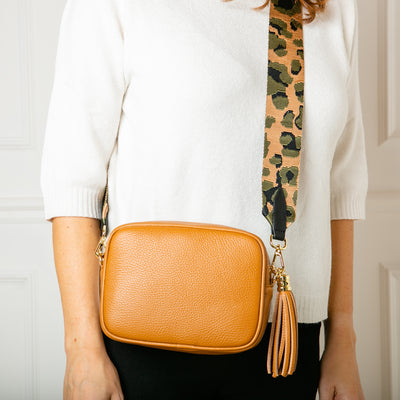 Italian leather cross body handbag in tan with animal print detachable bag strap model shot
