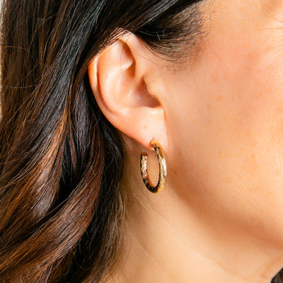 Cordelia gold hoops shown on model, easy to wear hoops, shiny finish