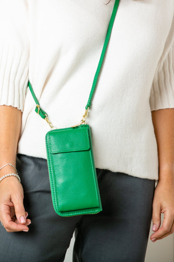 model shot of India leather bag with card slots and pocket, popper fastening and detachable cross strap in emerald