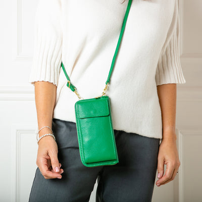 model shot of India leather bag with card slots and pocket, popper fastening and detachable cross strap in emerald
