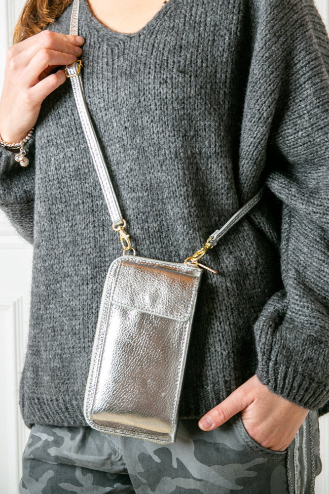 Leather cross body purse. model shot of Silver India leather crossbody bag with internal card slots and pocket, popper fastening and detachable strap