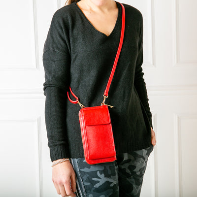 Leather cross body purse. Model shot our Red India leather bag with internal card slots and pocket, popper fastening and detachable cross body strap