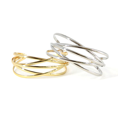 Ira bangle, lightbox image in both gold and silver, adjustable bangle, shiny finish, interlinked design 