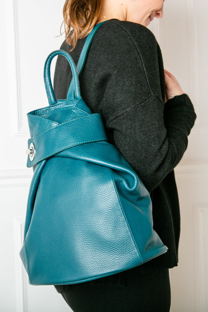 model shot of dark turq/teal Langton Italian leather backpack with top zip, silver clasp fastening and back pocket