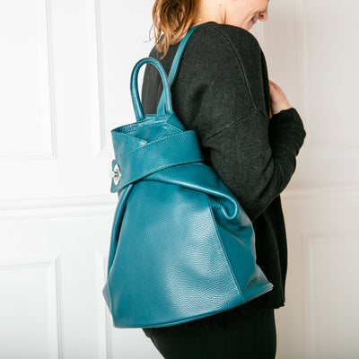 model shot of dark turq/teal Langton Italian leather backpack with top zip, silver clasp fastening and back pocket