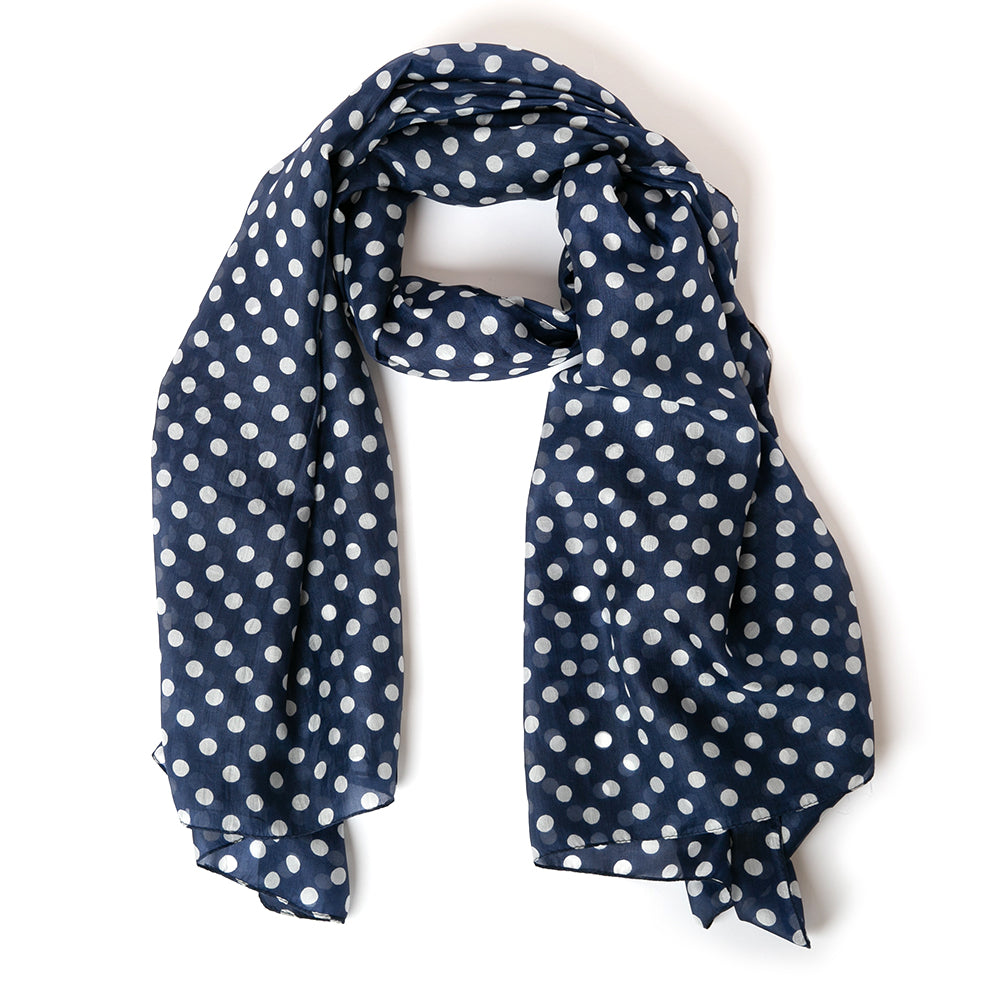 The Polka Dot silk scarf in navy blue, perfect for dressing up any outfit
