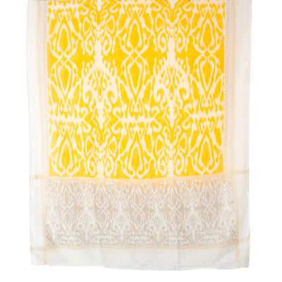 The New York Scarf in yellow featuring a bohemian print, perfect for wearing as a wrap or coverup on the beach