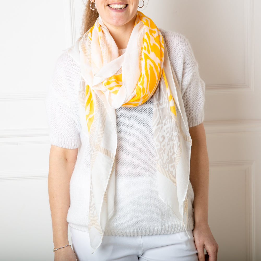 The New York Scarf in yellow with tones of grey and a white border around the edge 