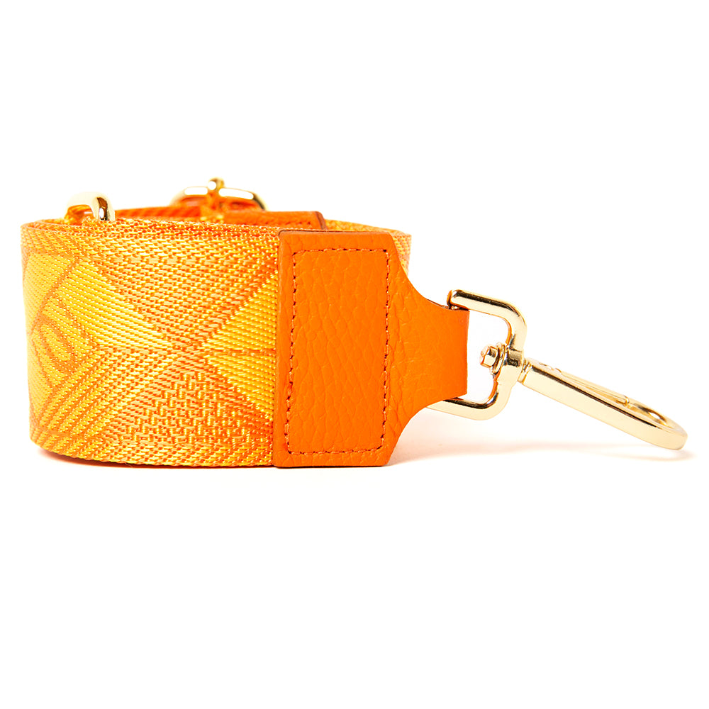 The detachable bag straps features gold or silver hardware, shown in orange and yellow cube print pattern, and is fully adjustable.