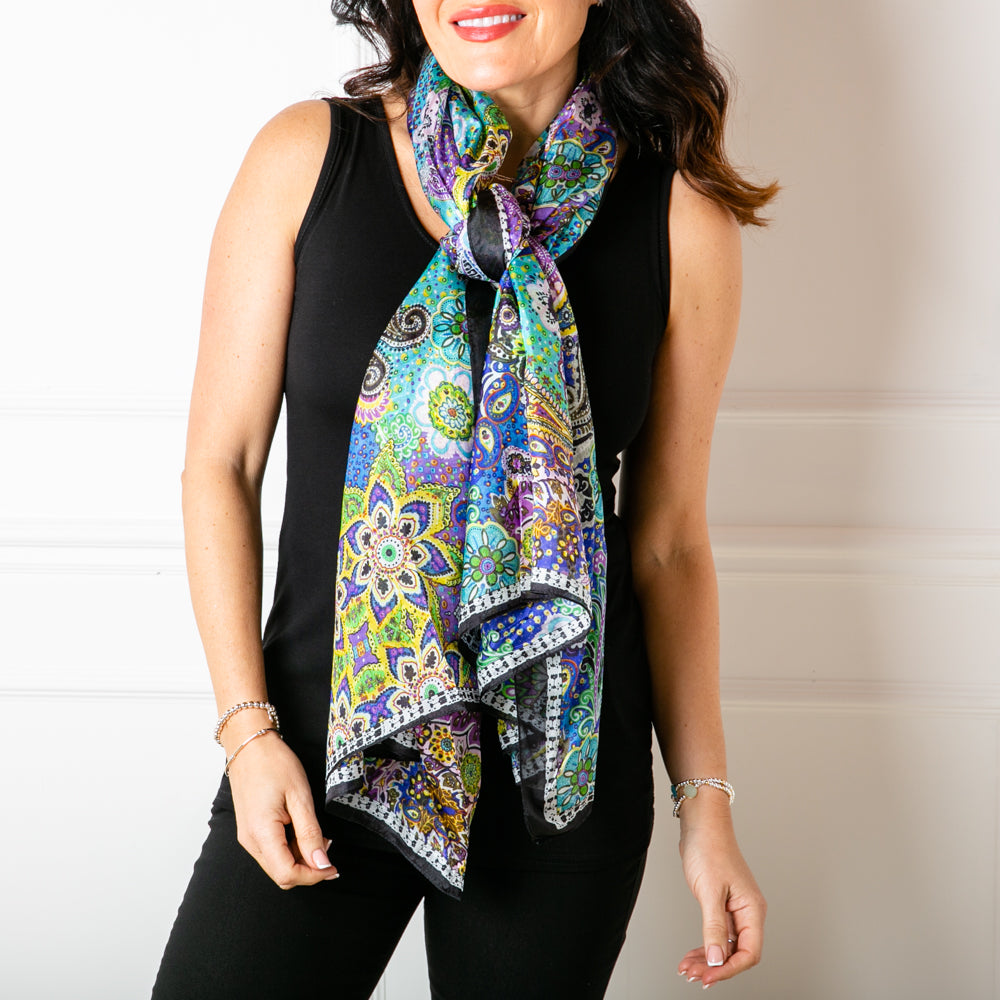 The Paisley Blossom Silk Scarf made from a soft delicate material that is 100% silk