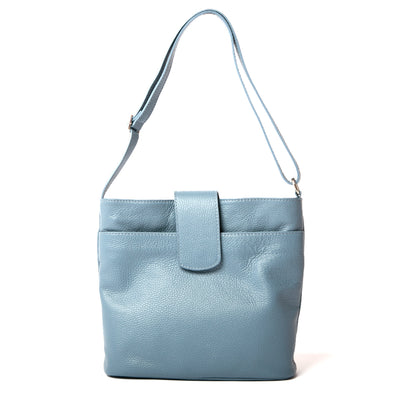 Pimlico Handbag in denim blue, shown from the front and including the adjustable leather strap, the fold over presstud fastening and the outside pocket. Made from Italian leather.