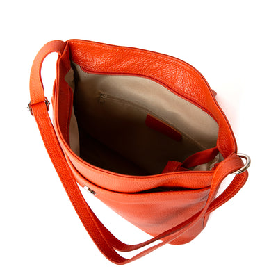 Pimlico Handbag in orange, pictured from above to show cream interior lining and inside zip pocket. Made from Italian leather.