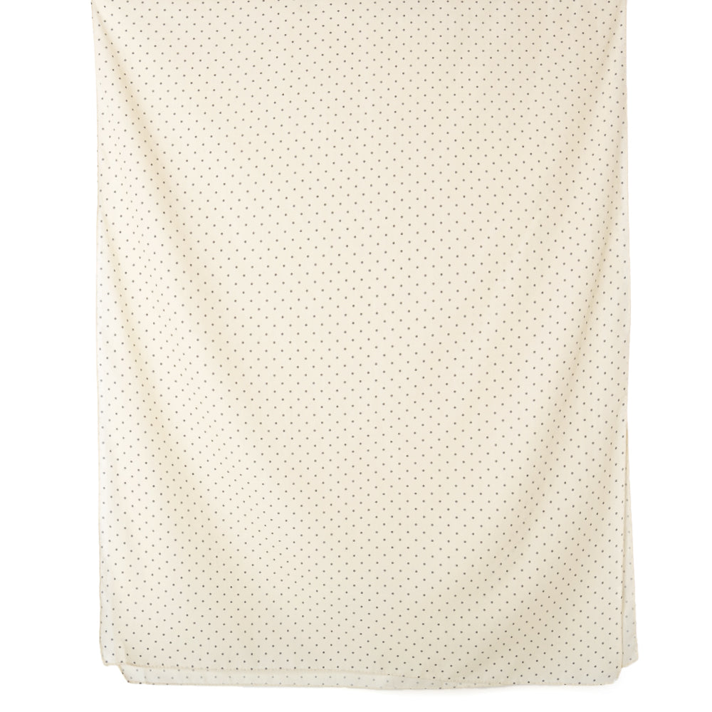 The Polka Dot scarf in cream, featuring a subtle spotty print, perfect for dressing up an outfit.